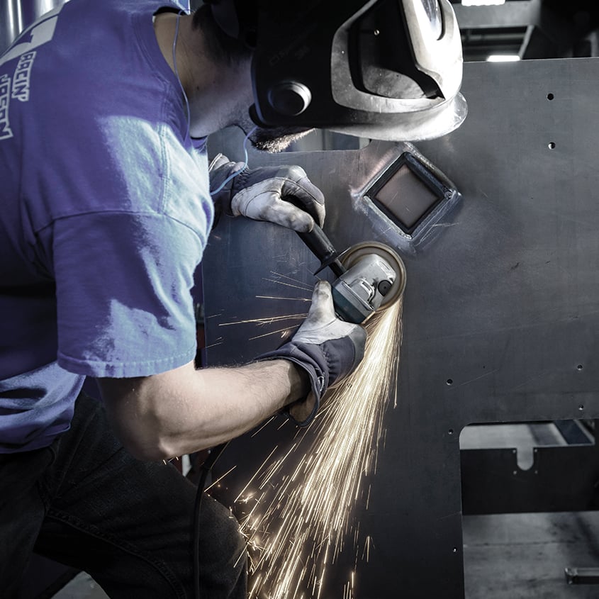 Schneider-employee-metal-grinding